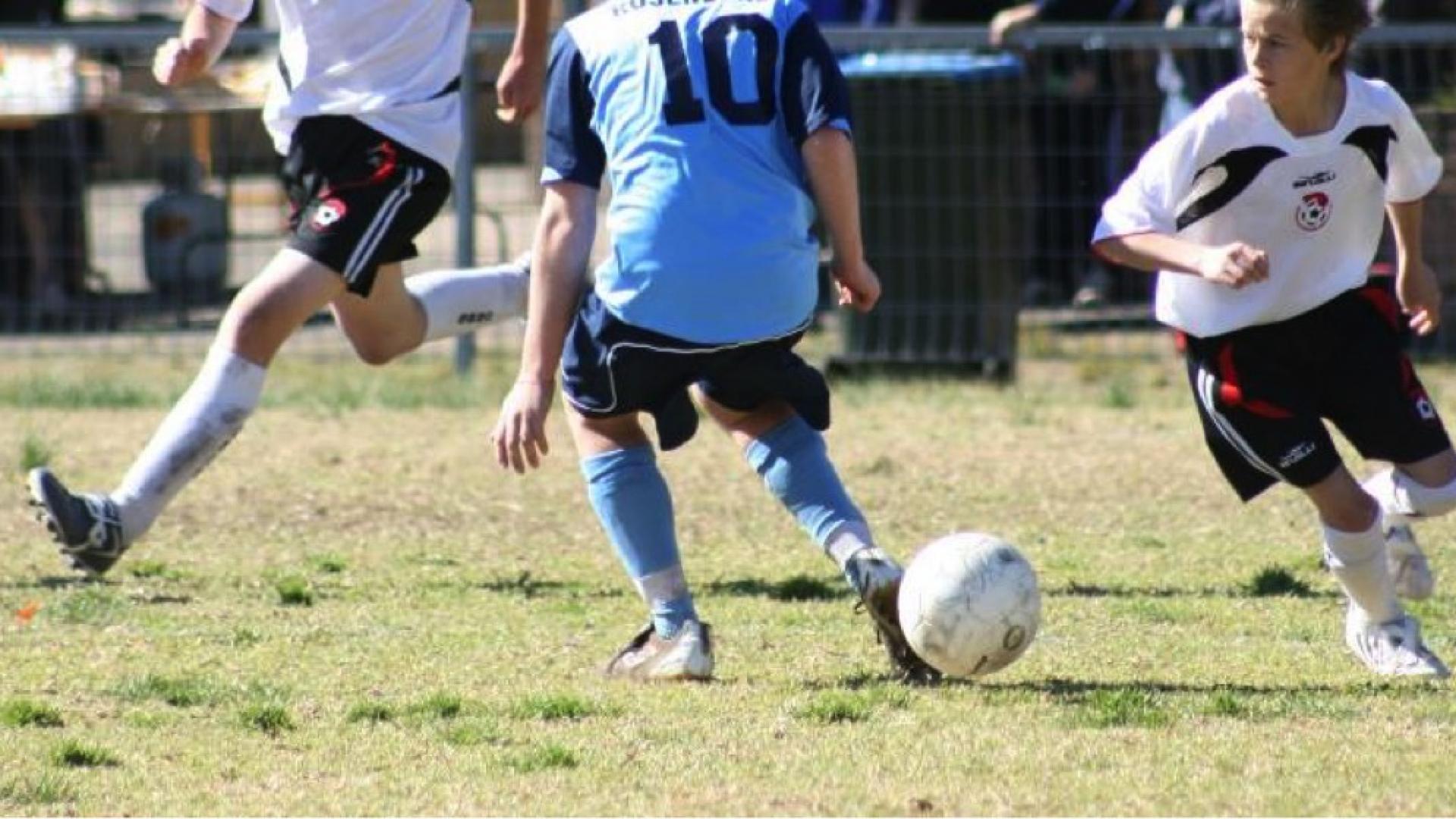 Dribbling a soccer ball around a player